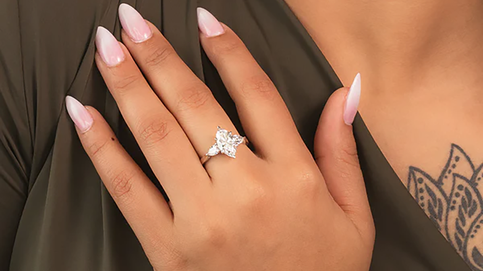Young woman hand wearing a marquise lab grown diamond engagement ring, Draco Diamond