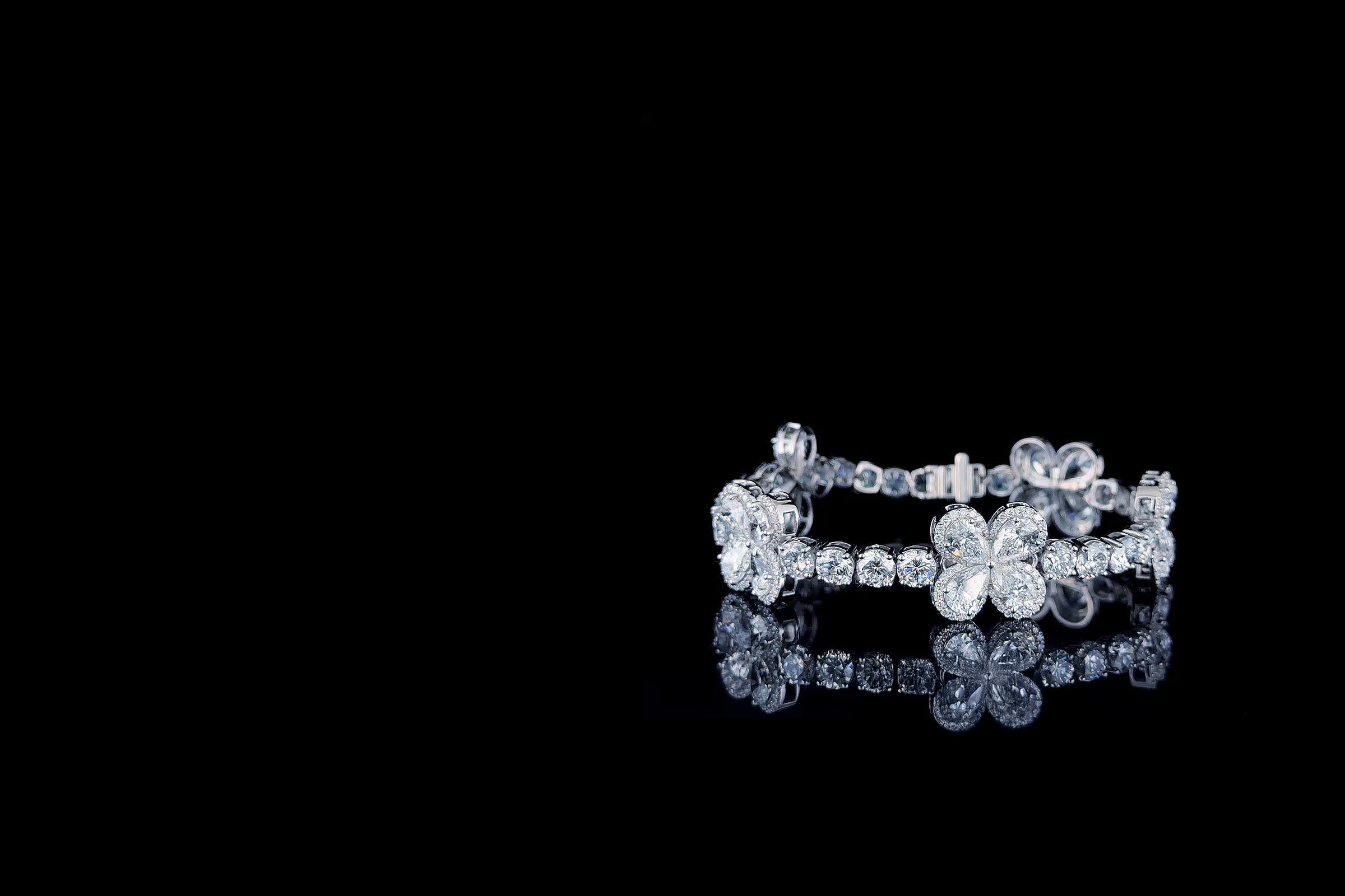 Lab grown diamond floral tennis bracelet on a dark reflective surface, IGI certified, Draco Diamond