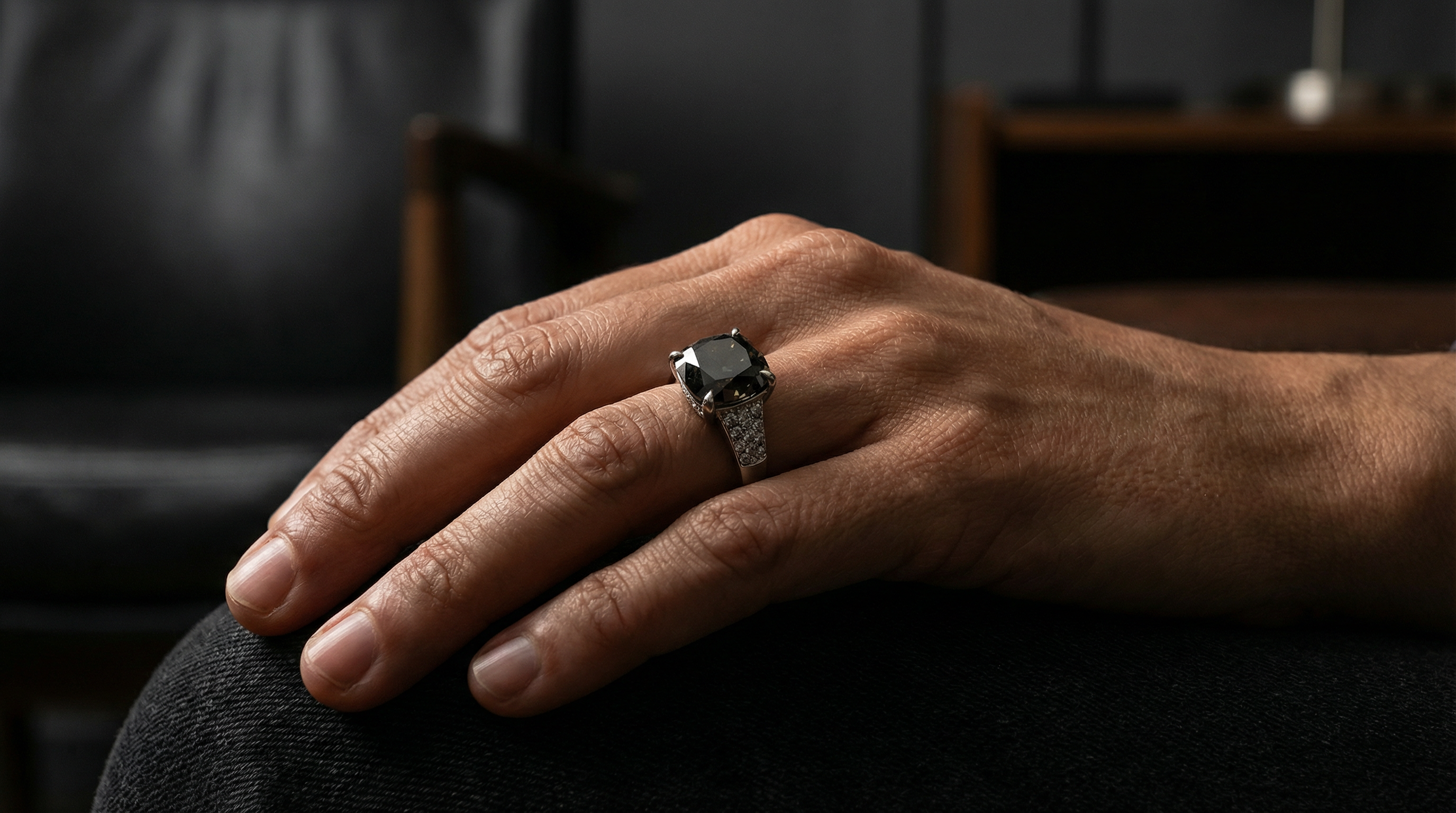 Cushion cut lab grown diamond ring worn on the hand in a refined interior, Draco Diamond