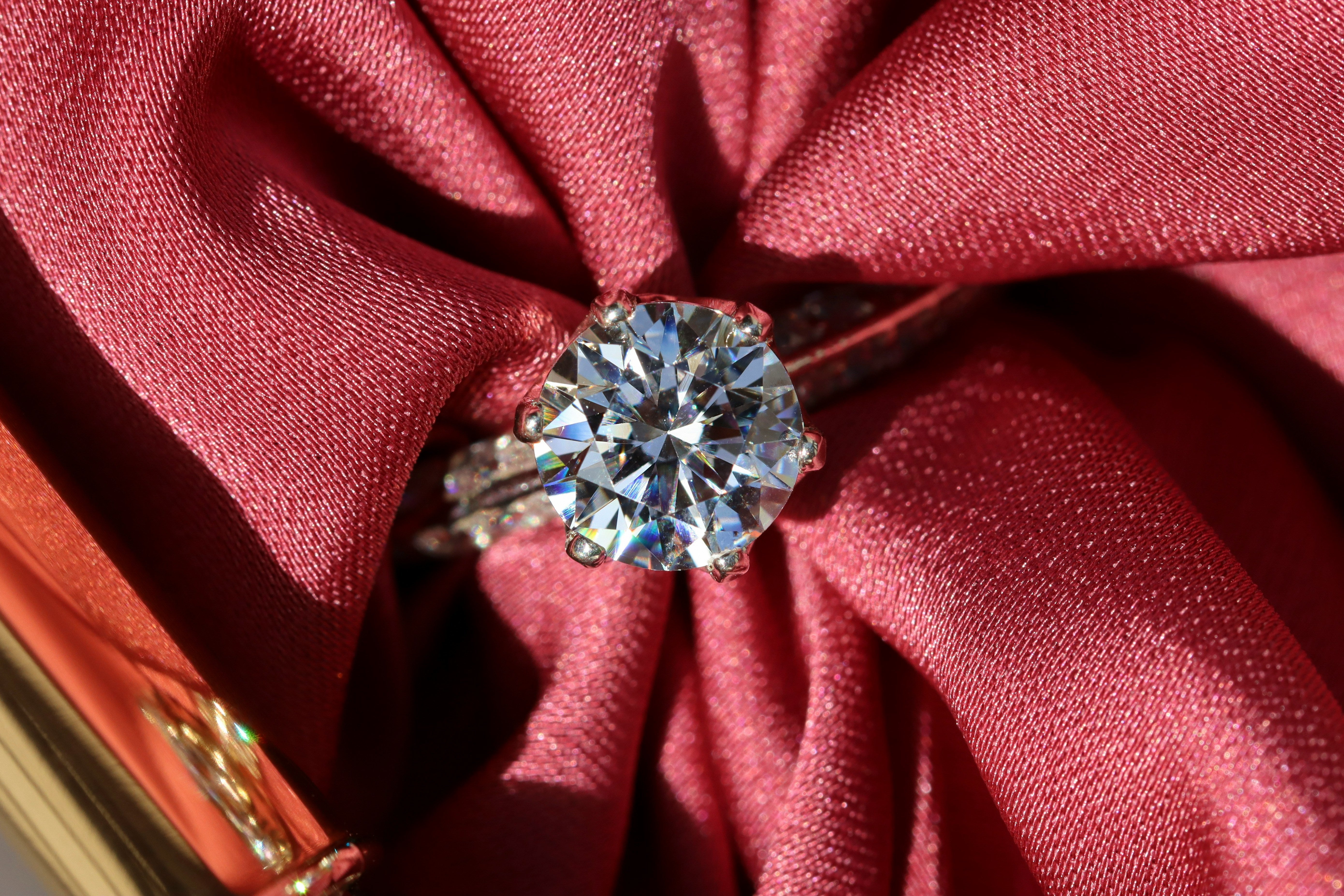 Macro view of a round brilliant lab grown diamond showing facet pattern, colour and clarity detail