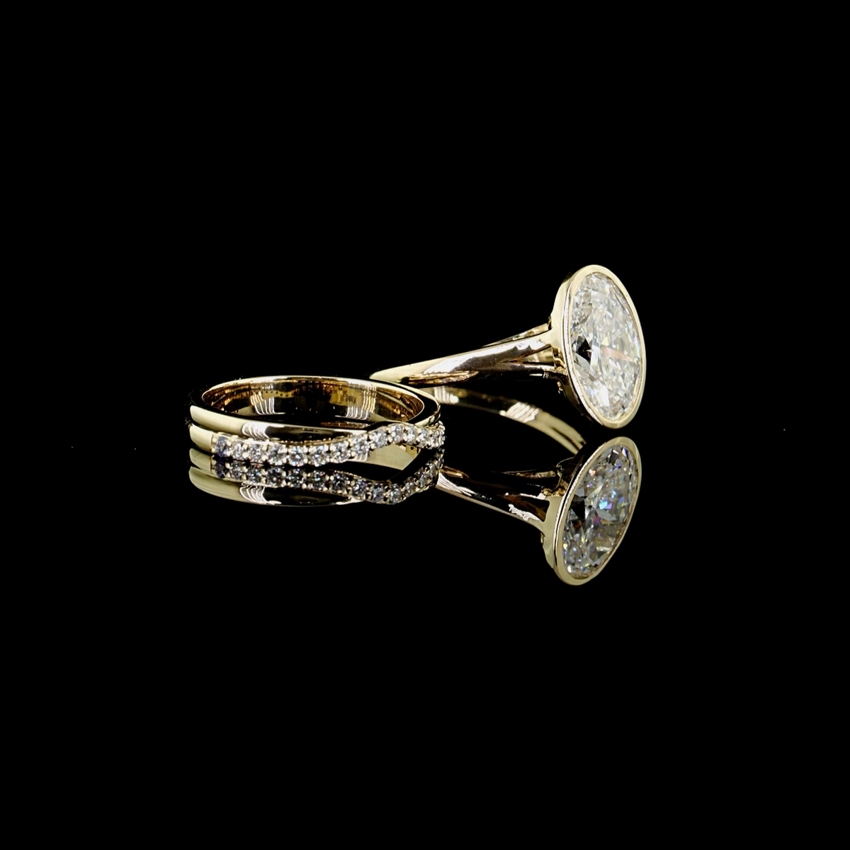 3ct oval bezel lab grown diamond bridal set, 14k yellow gold, real video still on black, engagement ring and matching pave band together