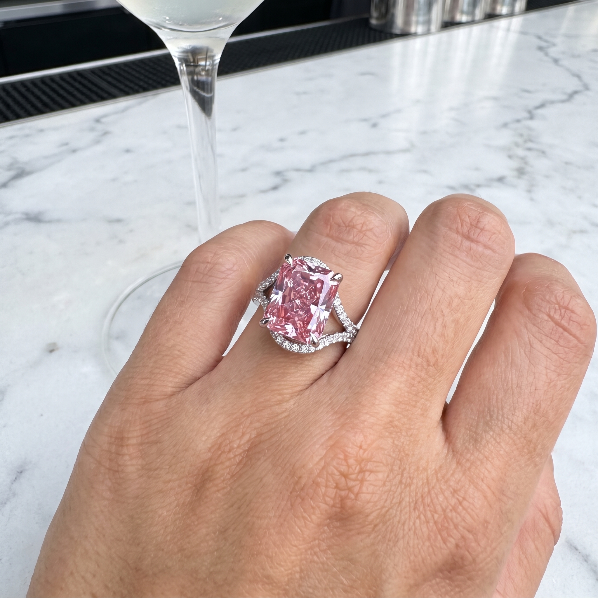 customer showing 5ct fancy pink radiant lab diamond ring, luxury lounge