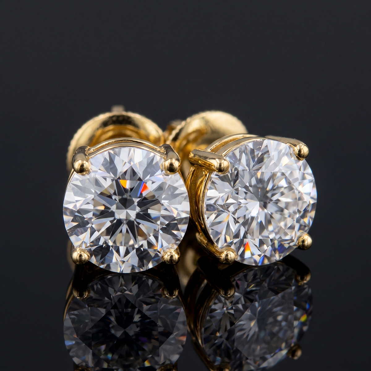 3ctw stud lab grown diamond earrings, on a black background
