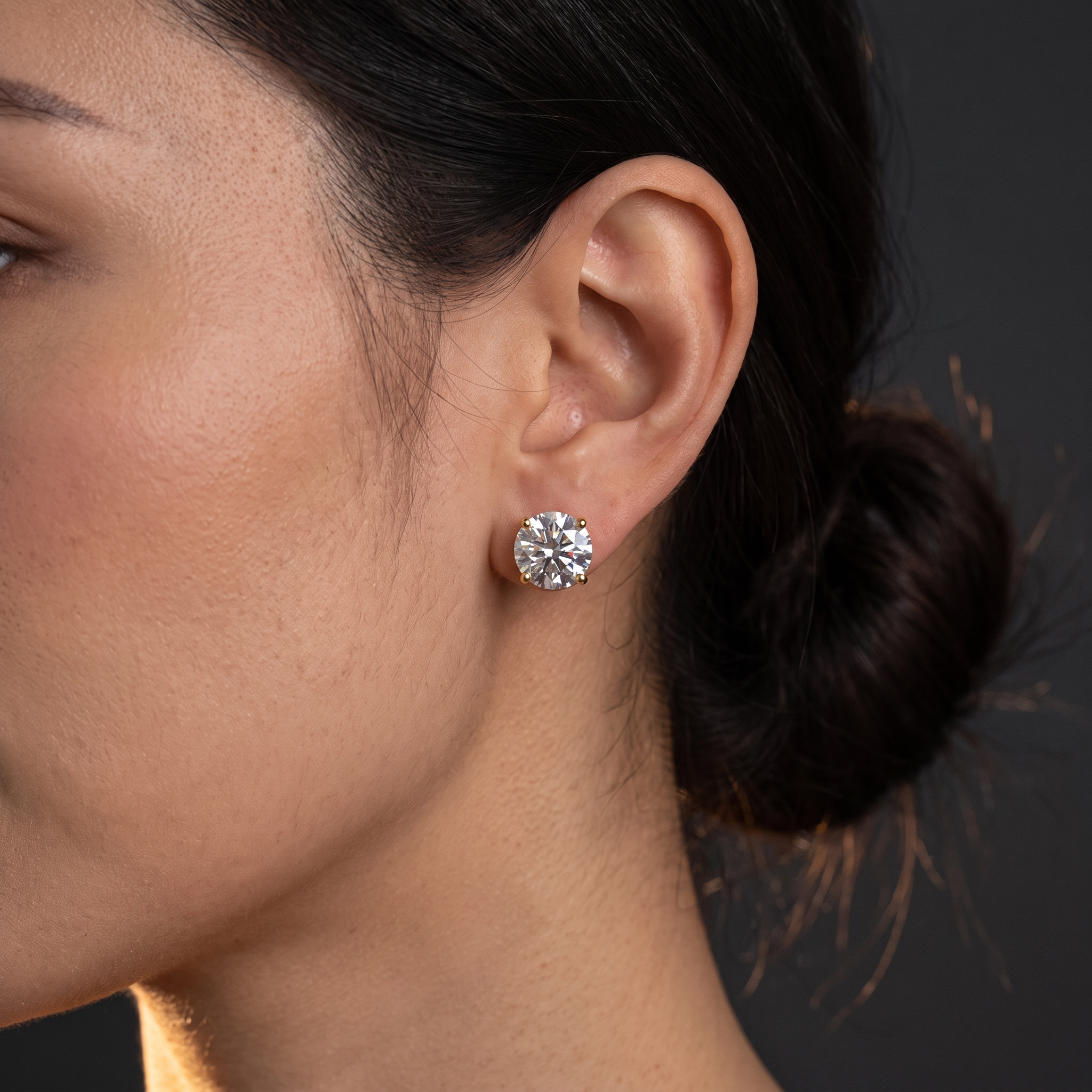2 carat lab grown diamond stud earring worn on ear, evening close up