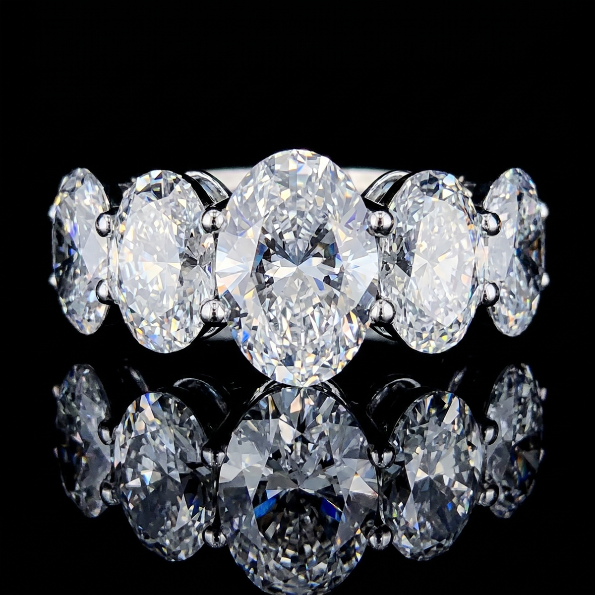 8.5ct oval five stone lab grown diamond ring, on a black background