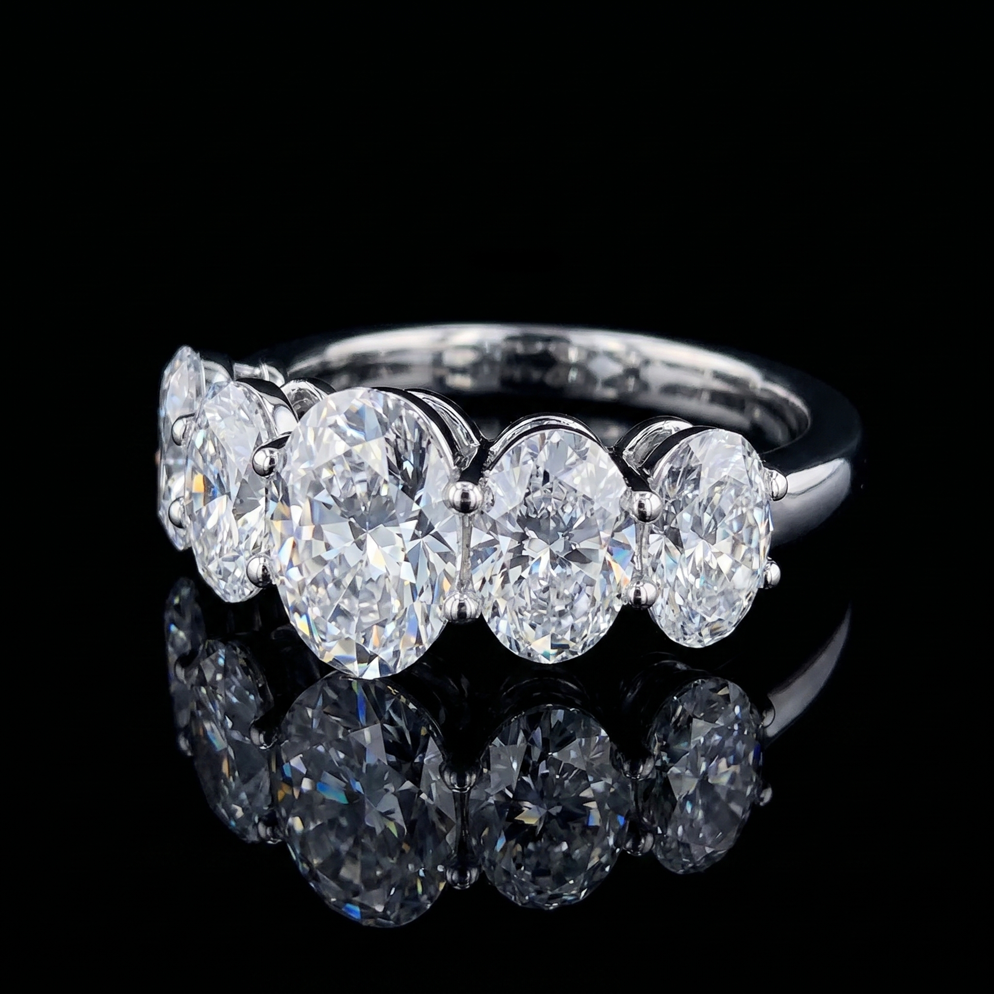 8.5ct oval five stone lab grown diamond ring, on a black background