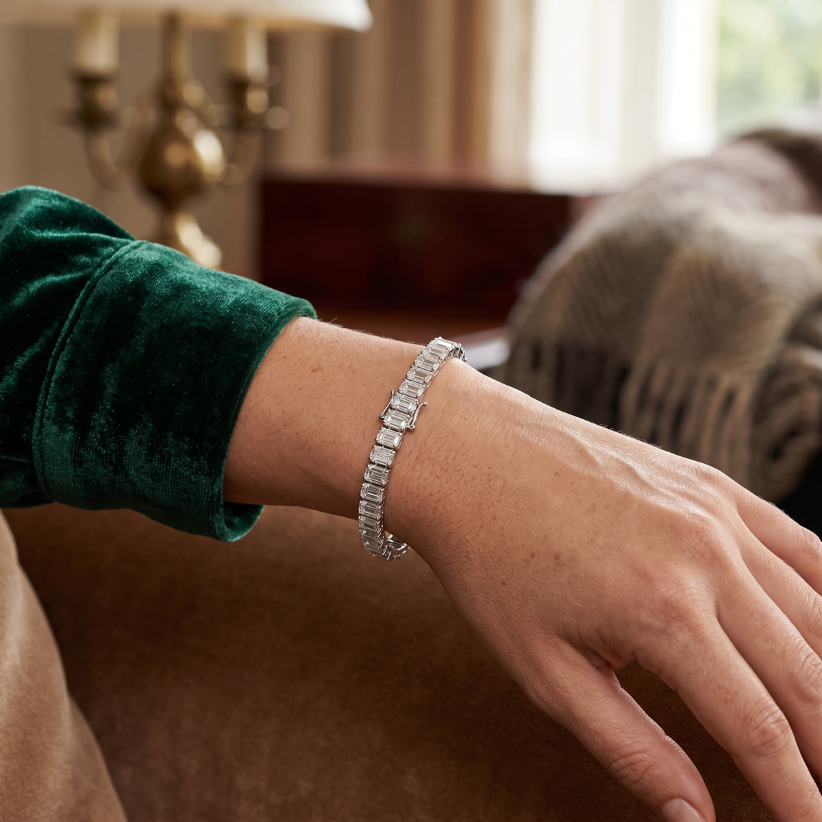 31.87ct emerald cut lab grown diamond tennis bracelet worn on wrist, lifestyle editorial