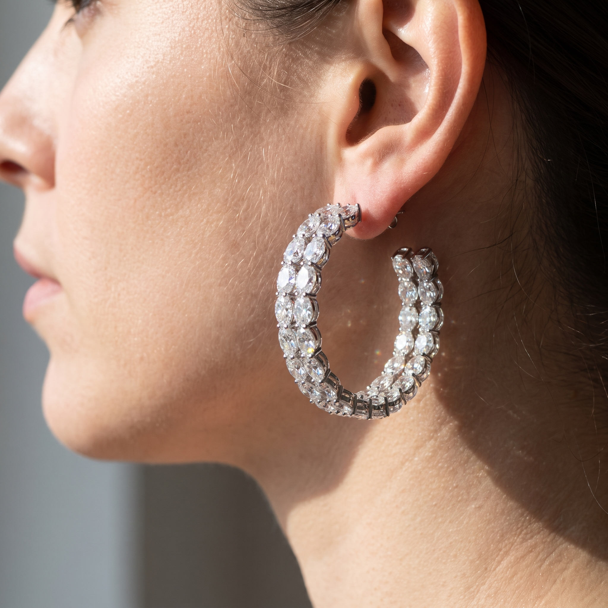 woman wearing 11ctw oval inside-out lab diamond hoop, true scale