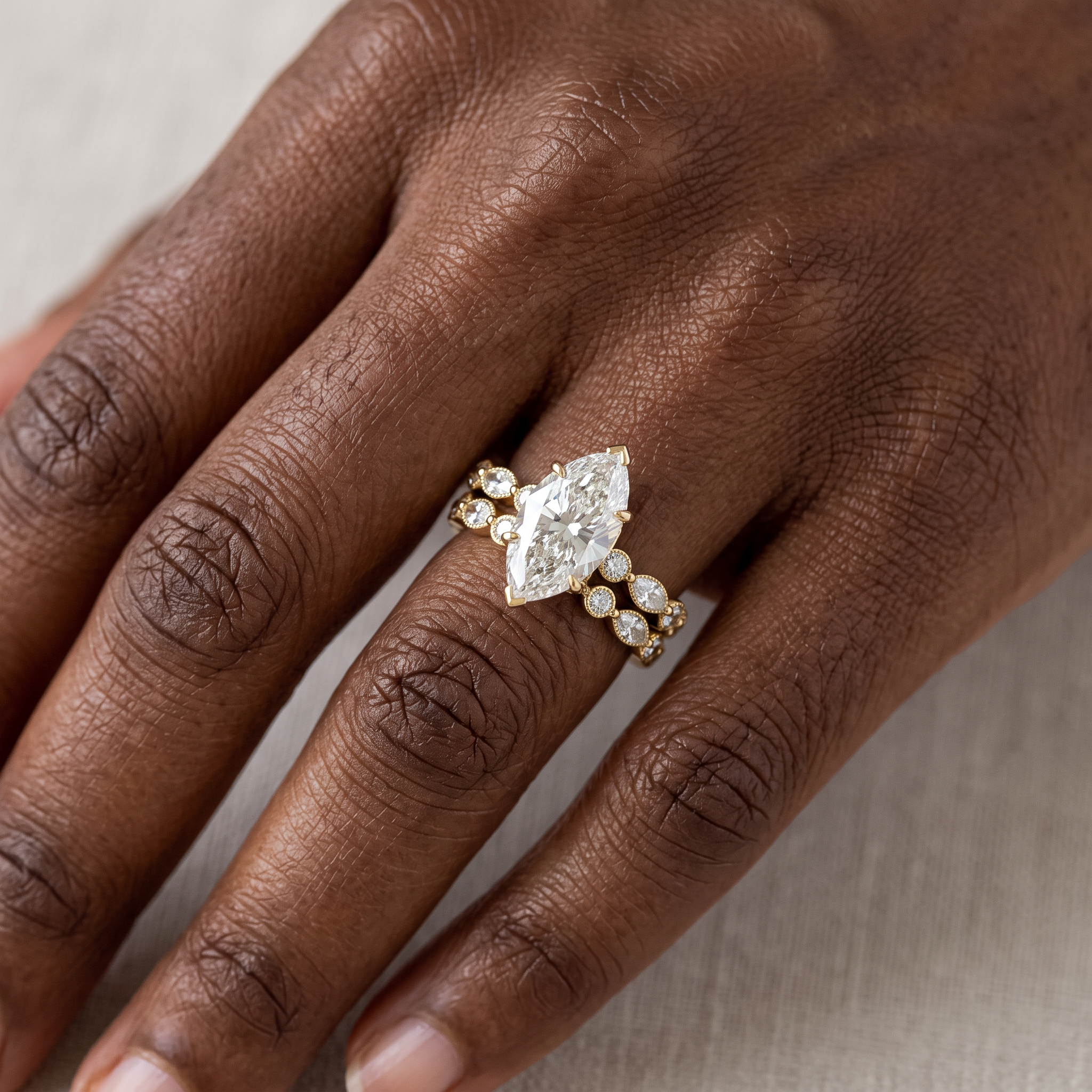 3ct marquise lab grown diamond bridal set worn on the hand, ring and band stacked, three-quarter view