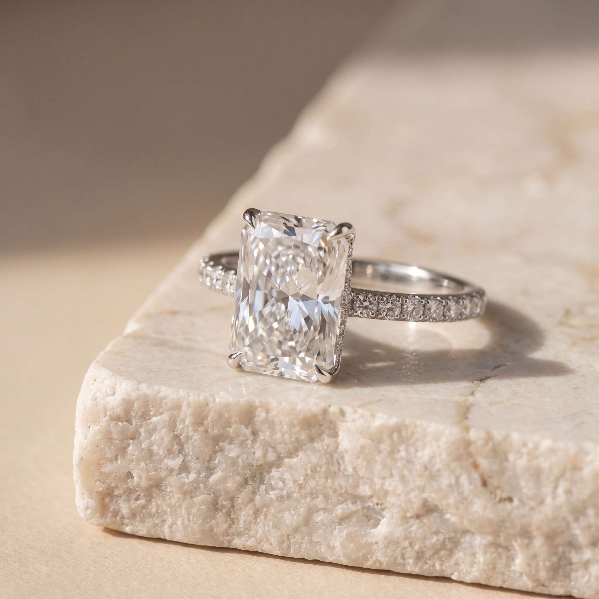 5ct radiant cut lab grown diamond engagement ring resting on a natural stone ledge, editorial styling