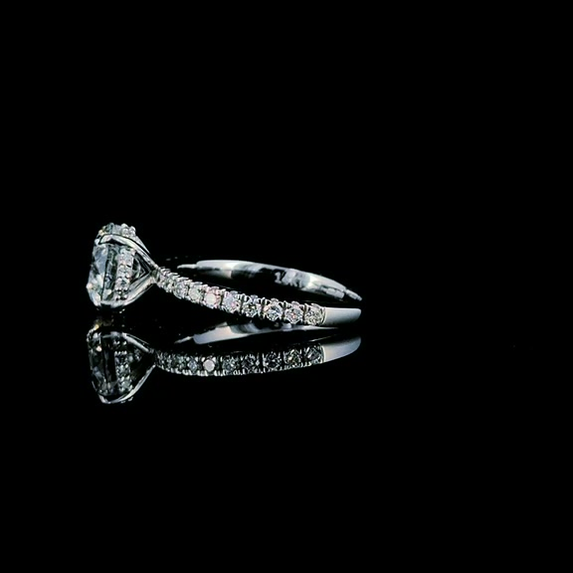 2ct round brilliant lab grown diamond engagement ring on black, side view showing the pave shoulders