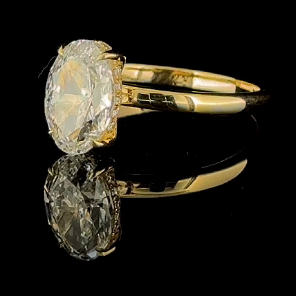 3ct oval lab grown diamond ring, 14k yellow gold, real video still on black, oval and four claws from the side