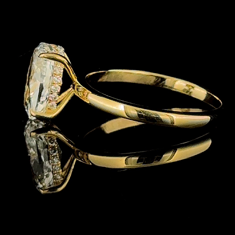 3ct oval lab grown diamond ring, 14k yellow gold, real video still on black, side profile of the four claws