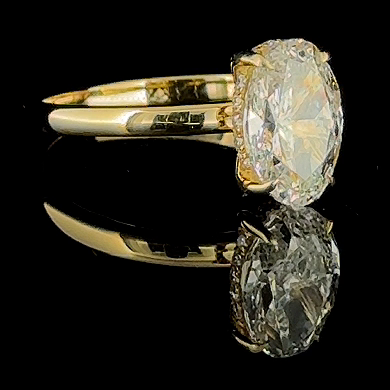 3ct oval lab grown diamond ring, 14k yellow gold, real video still on black, three quarter view
