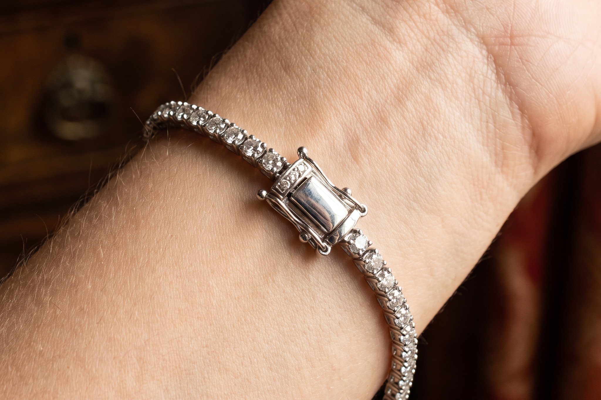 Close up of a lab grown diamond tennis bracelet box clasp and safety catch fastened on the wrist, Draco Diamond