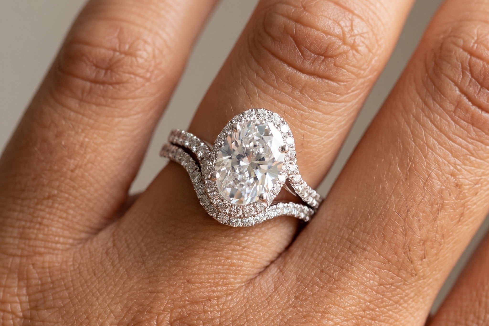 Oval halo lab grown diamond bridal set worn on the hand in white gold, Draco Diamond
