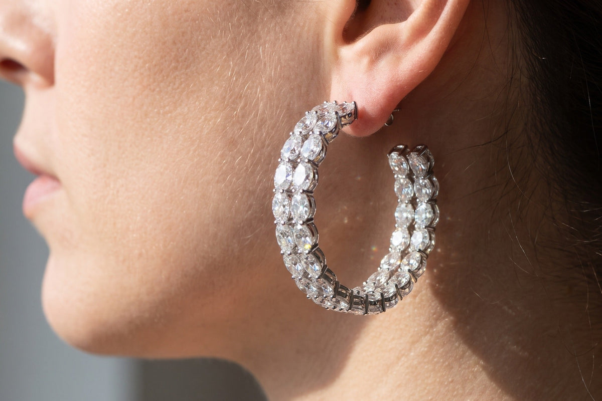 Profile view of an inside out lab grown diamond hoop earring worn on the ear in daylight, outer and inner rows of diamonds both visible, Draco Diamond