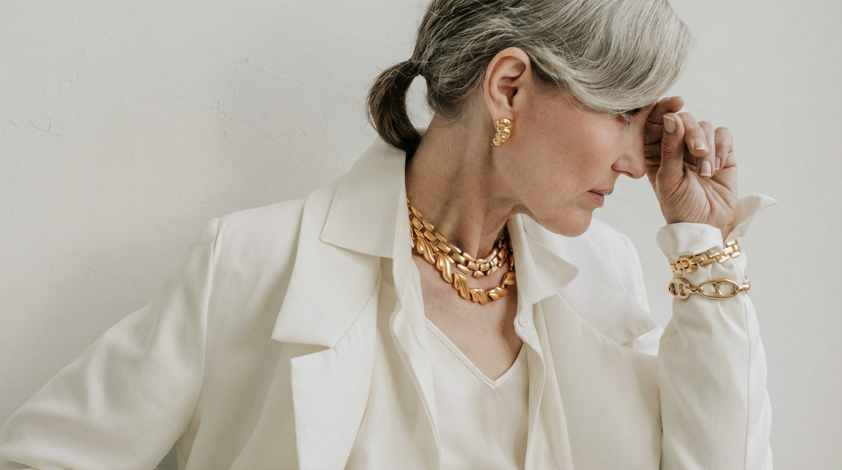 Professional woman in tailored cream styling with fine jewellery, IGI certified, Draco Diamond, Canada