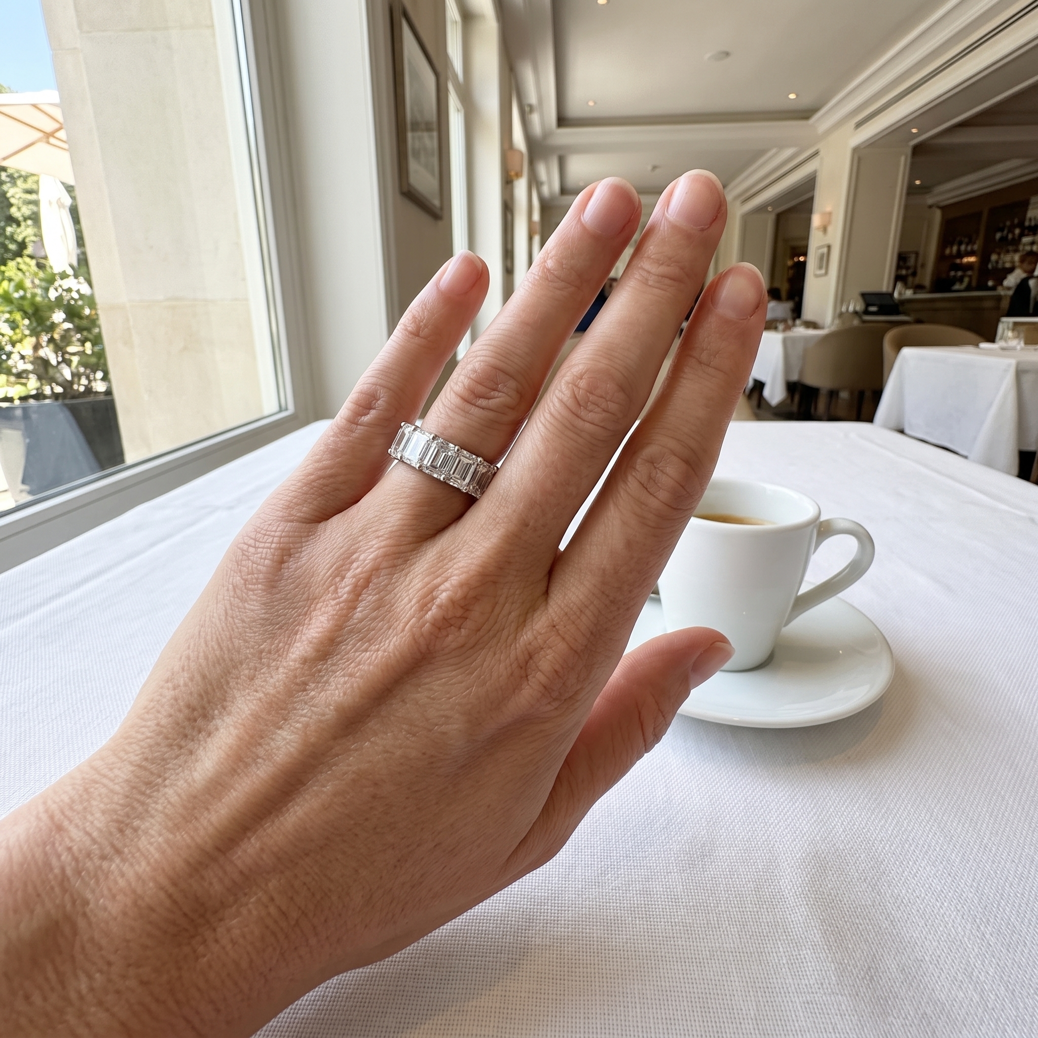 customer wearing 8ct emerald lab grown diamond eternity band at a cafe