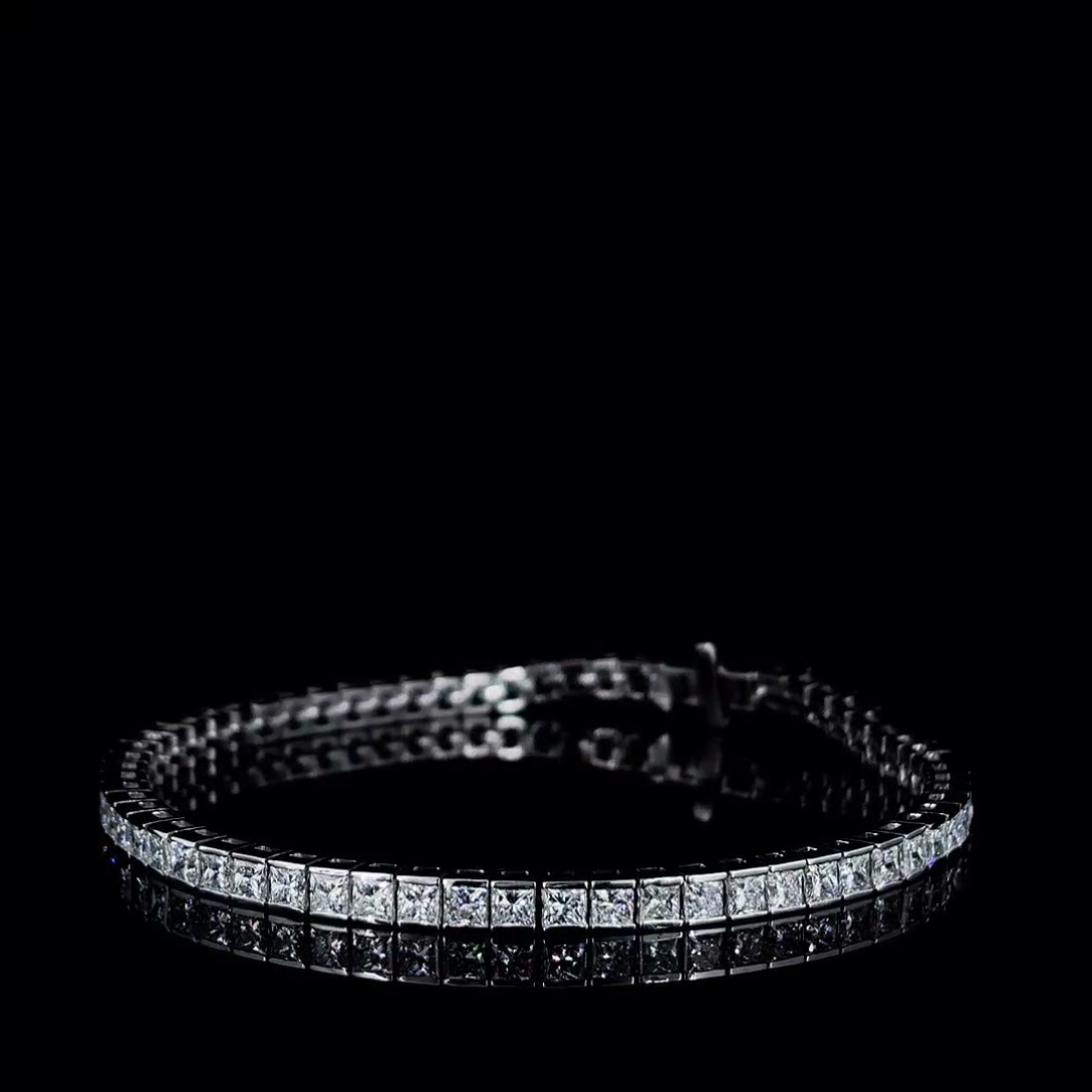 7ctw princess cut lab grown diamond tennis bracelet on black, angled view of the bezel set line