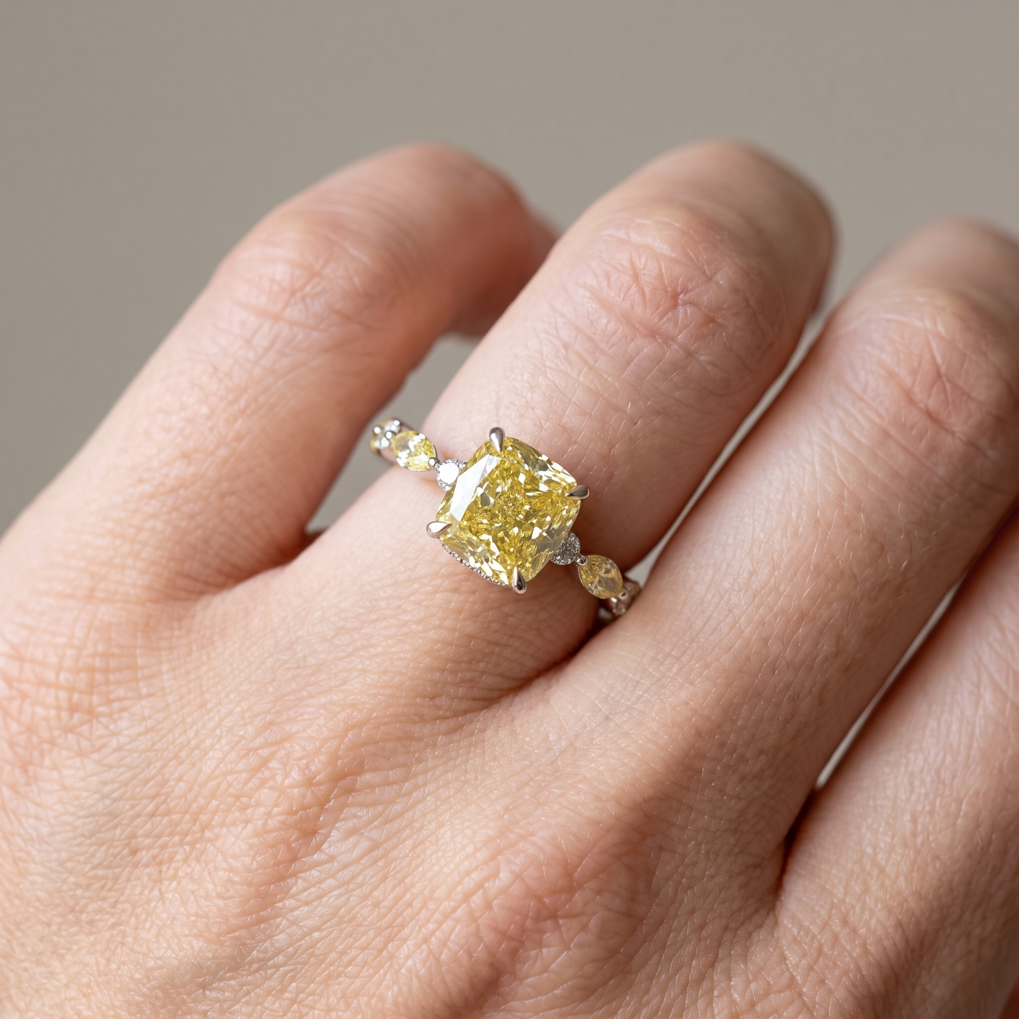 4.3ctw fancy yellow cushion lab grown diamond engagement ring worn on the hand