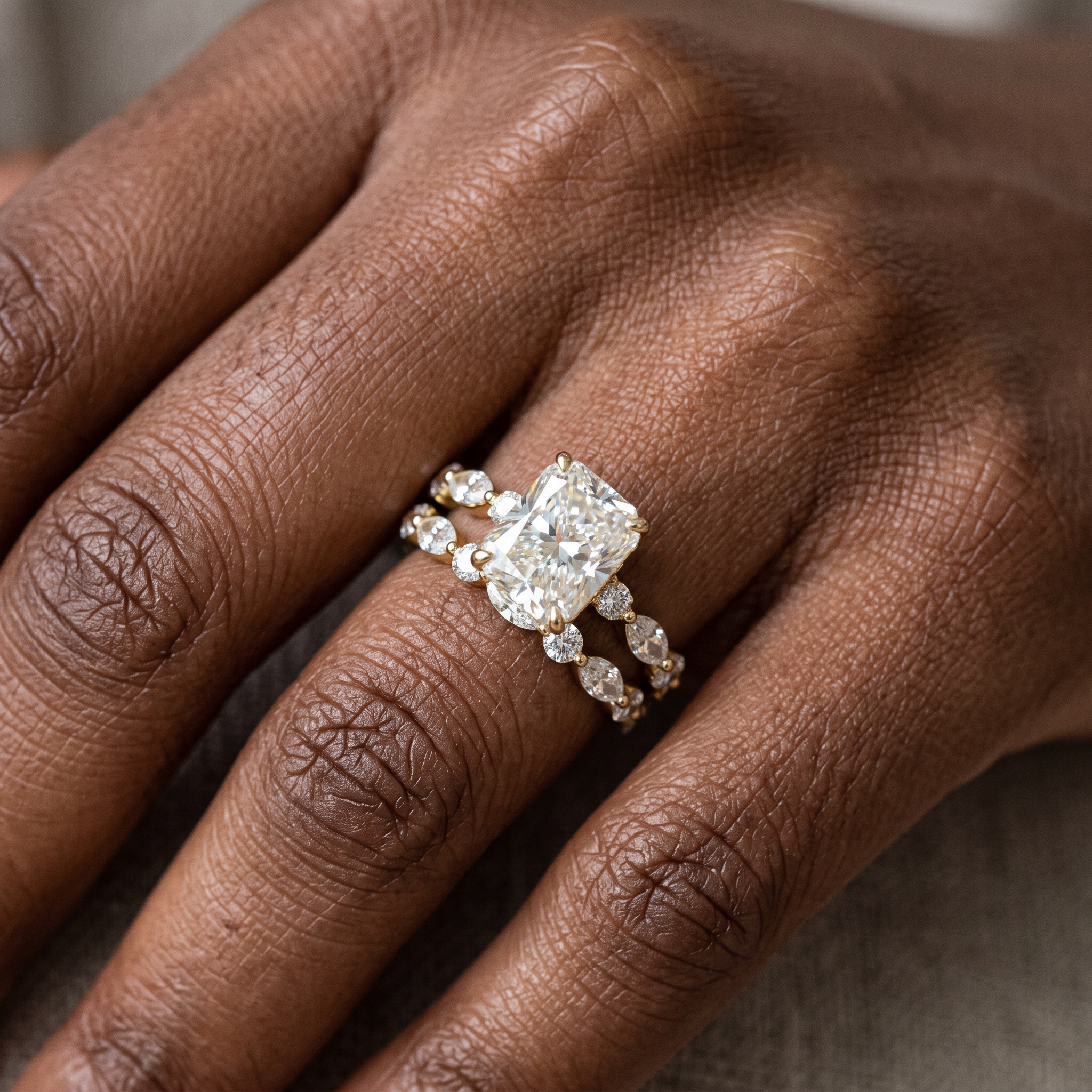 3ct radiant lab grown diamond bridal set worn on the hand, close-up of ring stacked with band