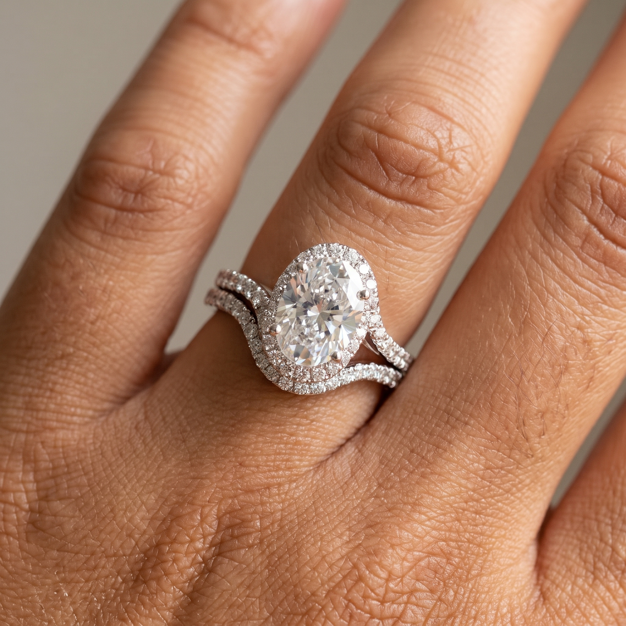 3ct oval halo white gold bridal set worn on the hand, ring and band stacked flush