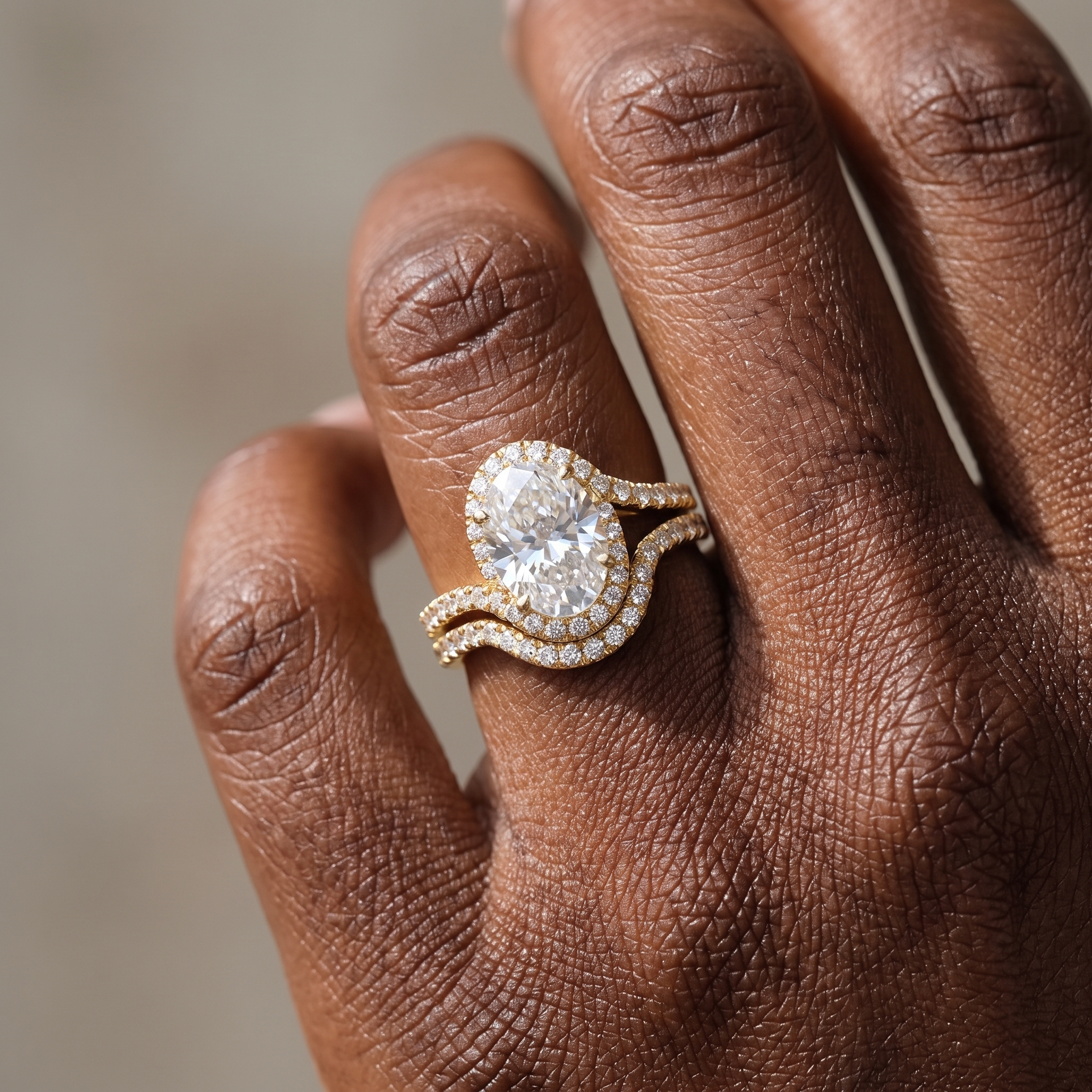 3ct oval halo yellow gold bridal set worn on the hand, engagement ring and matching band stacked flush