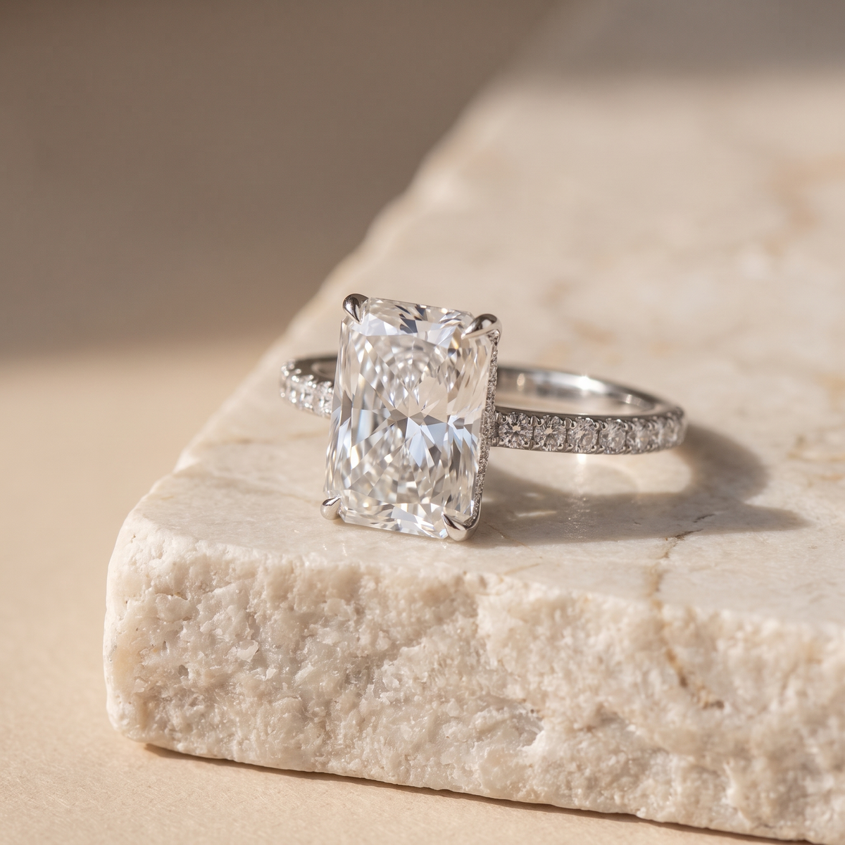 5ct radiant cut lab grown diamond engagement ring resting on a natural stone ledge, editorial styling