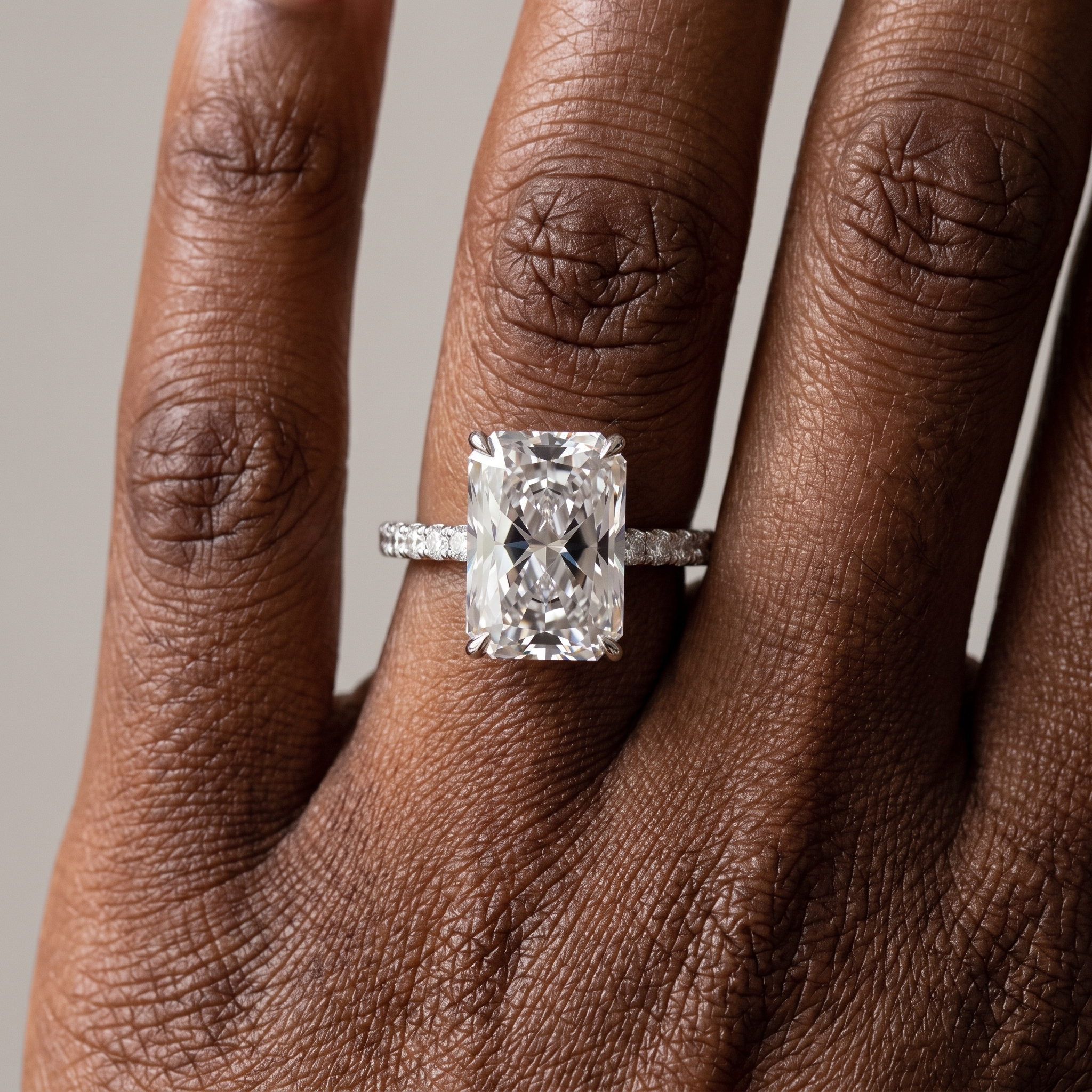 5ct radiant cut lab grown diamond engagement ring worn on the hand, three quarter view