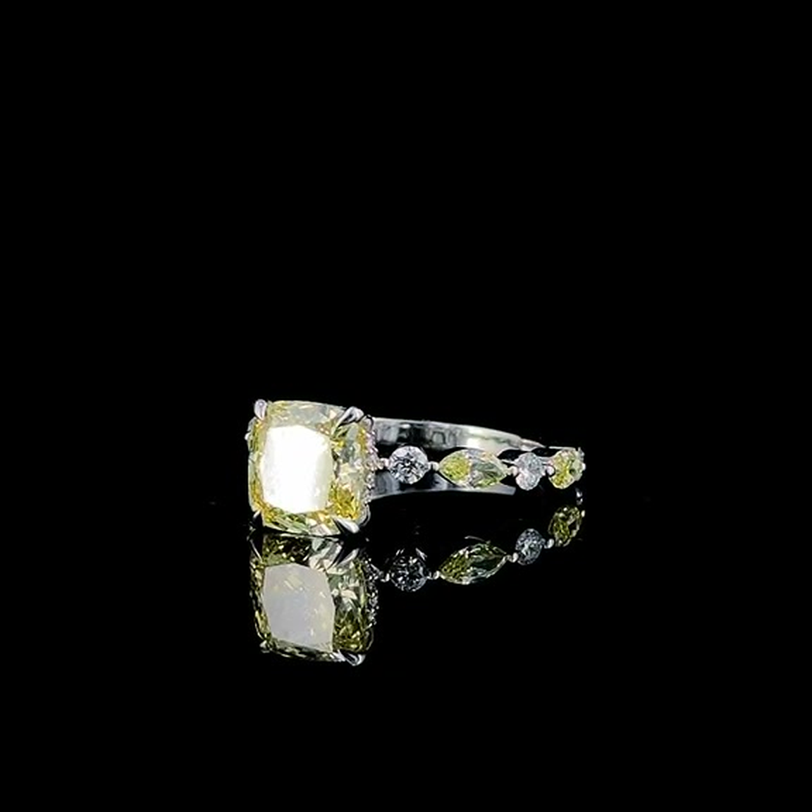 3ct fancy yellow cushion lab grown diamond ring on black, three-quarter view from the left
