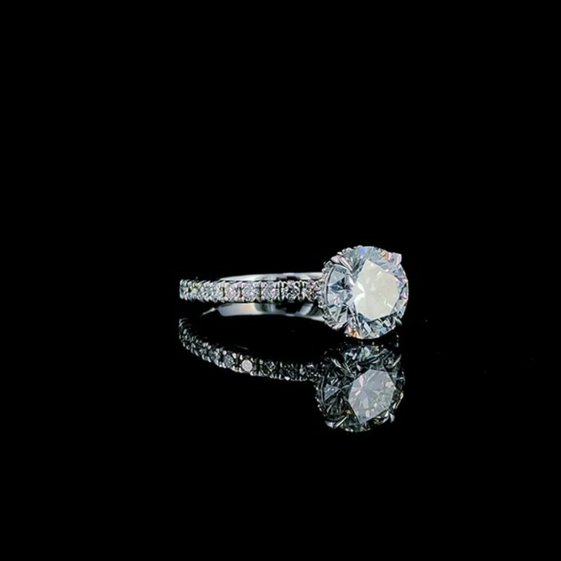 2ct round brilliant lab grown diamond engagement ring on black, three-quarter view with the hidden halo visible