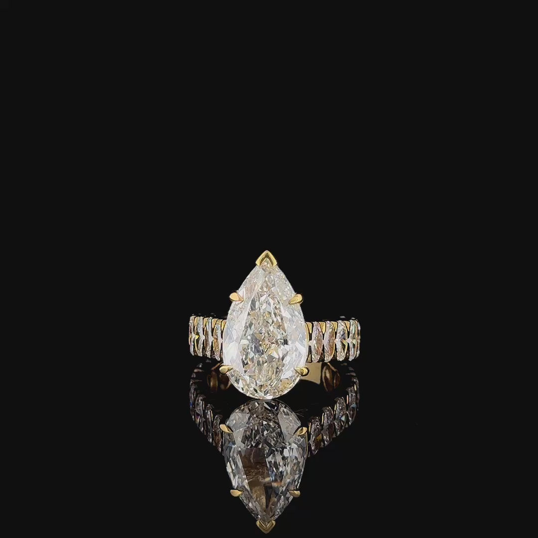 7ct pear lab grown diamond engagement ring rotating on turntable