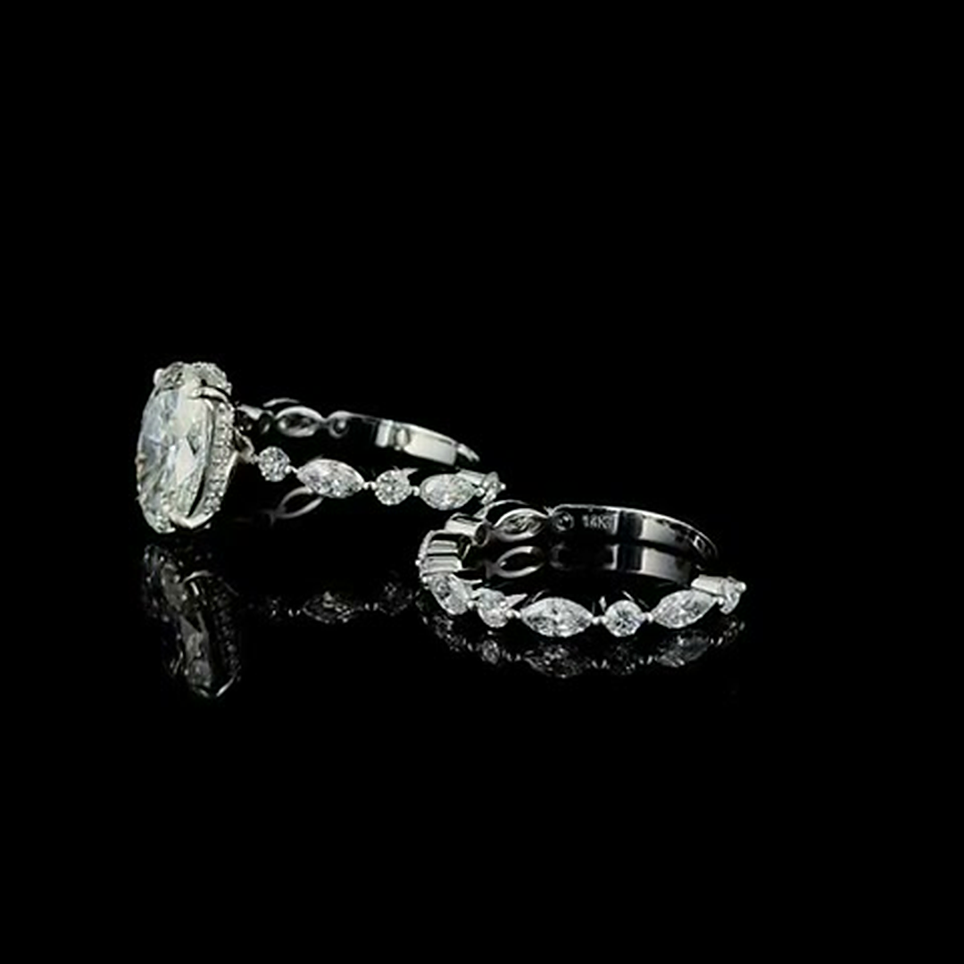 3ct oval lab grown diamond bridal set in white gold on black, three-quarter view with marquise and round accents