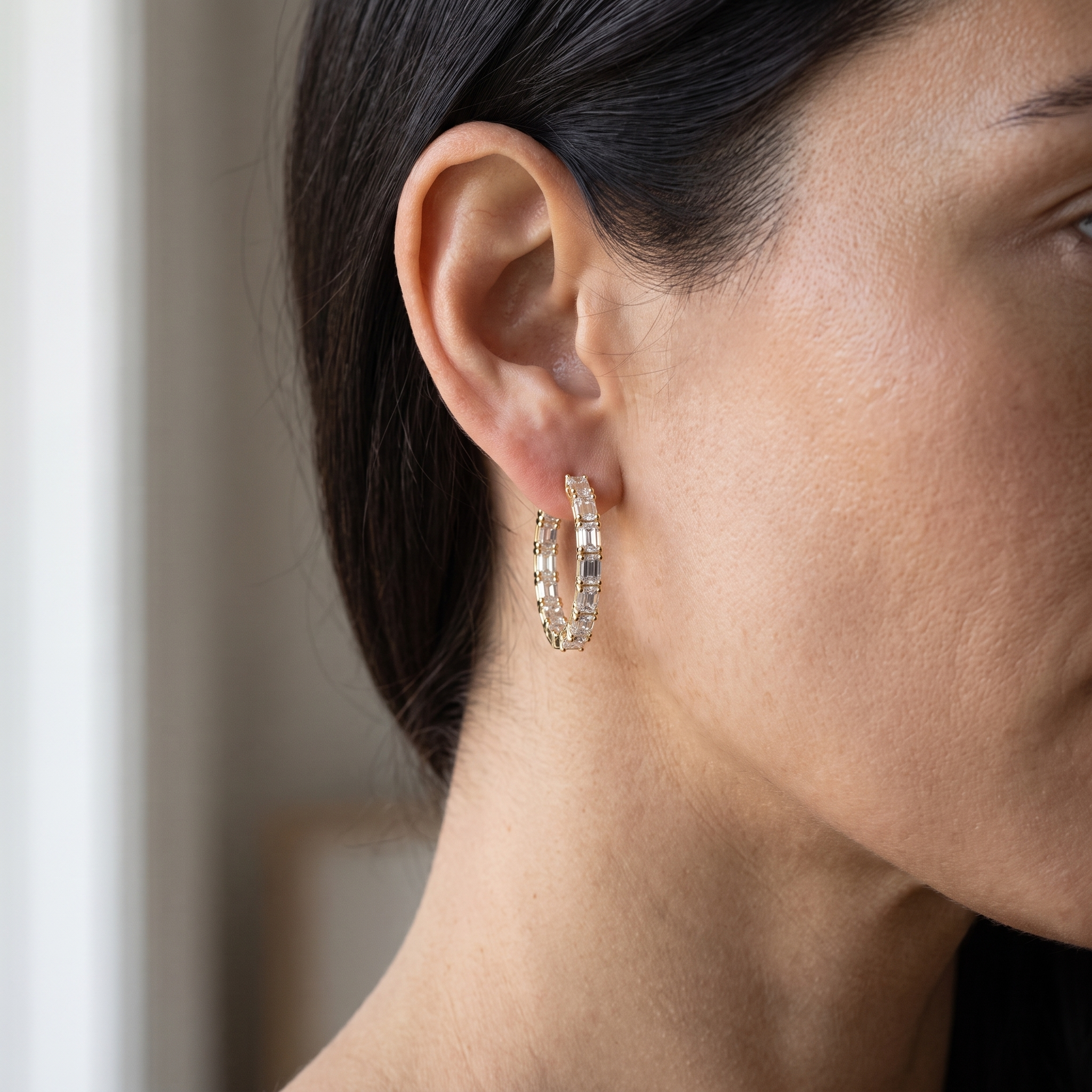 woman wearing 6ctw baguette lab diamond hoop earring, profile