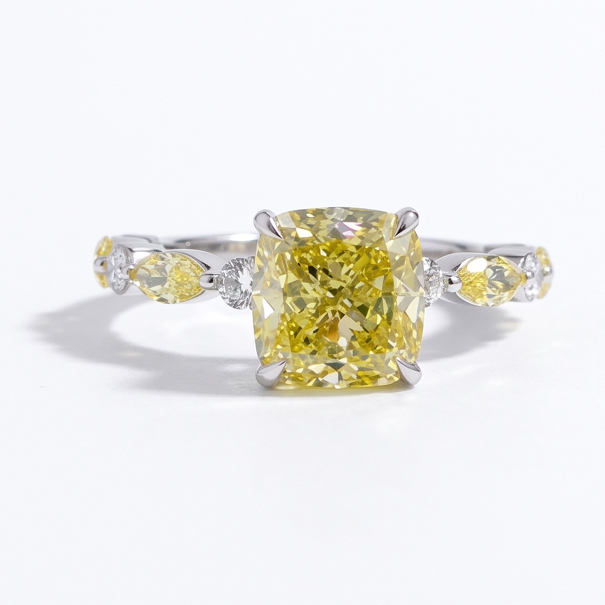 4.3ctw fancy yellow cushion cut lab grown diamond engagement ring, front view on a white studio background