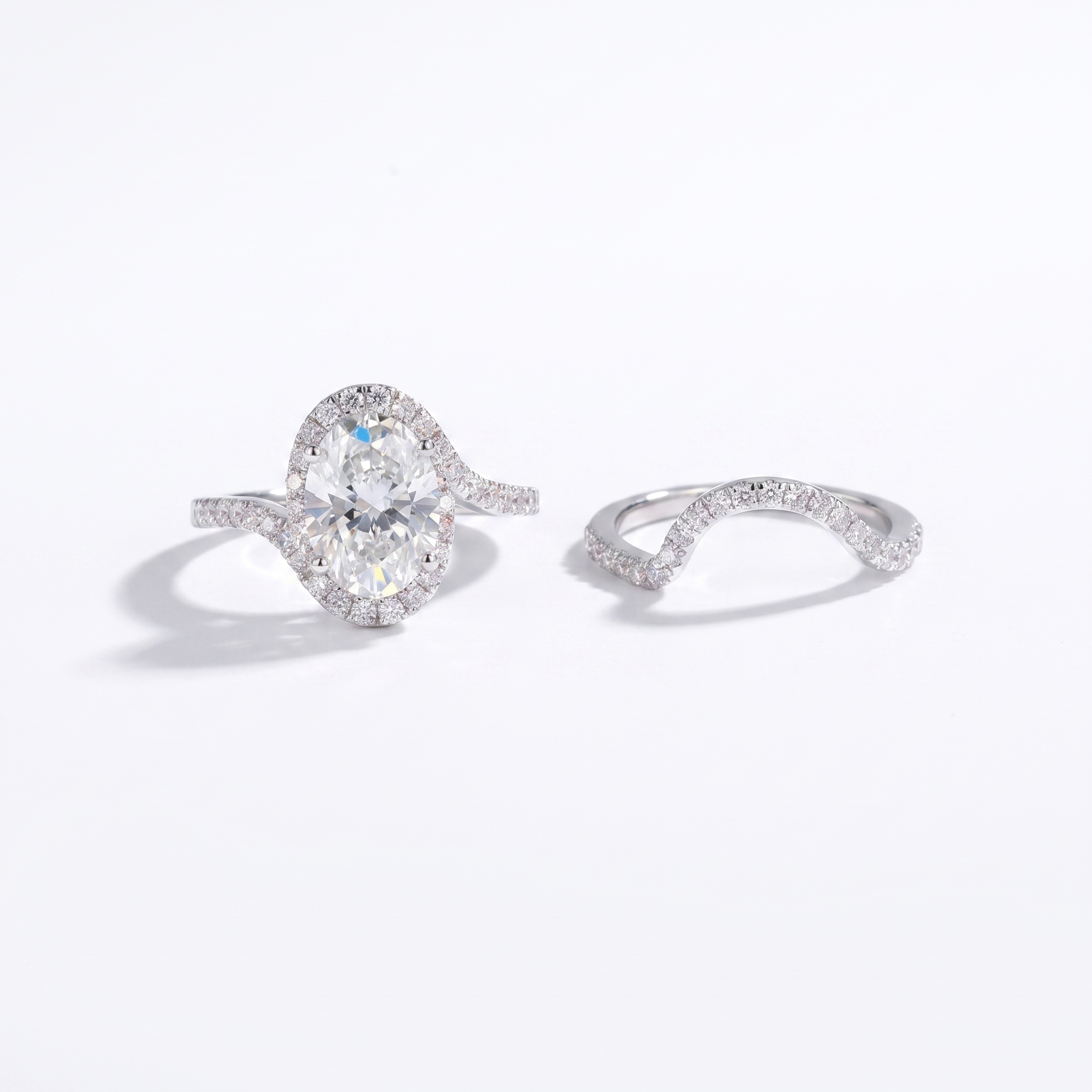 3ct oval halo lab grown diamond bridal set in white gold, engagement ring and matching band, front view on white