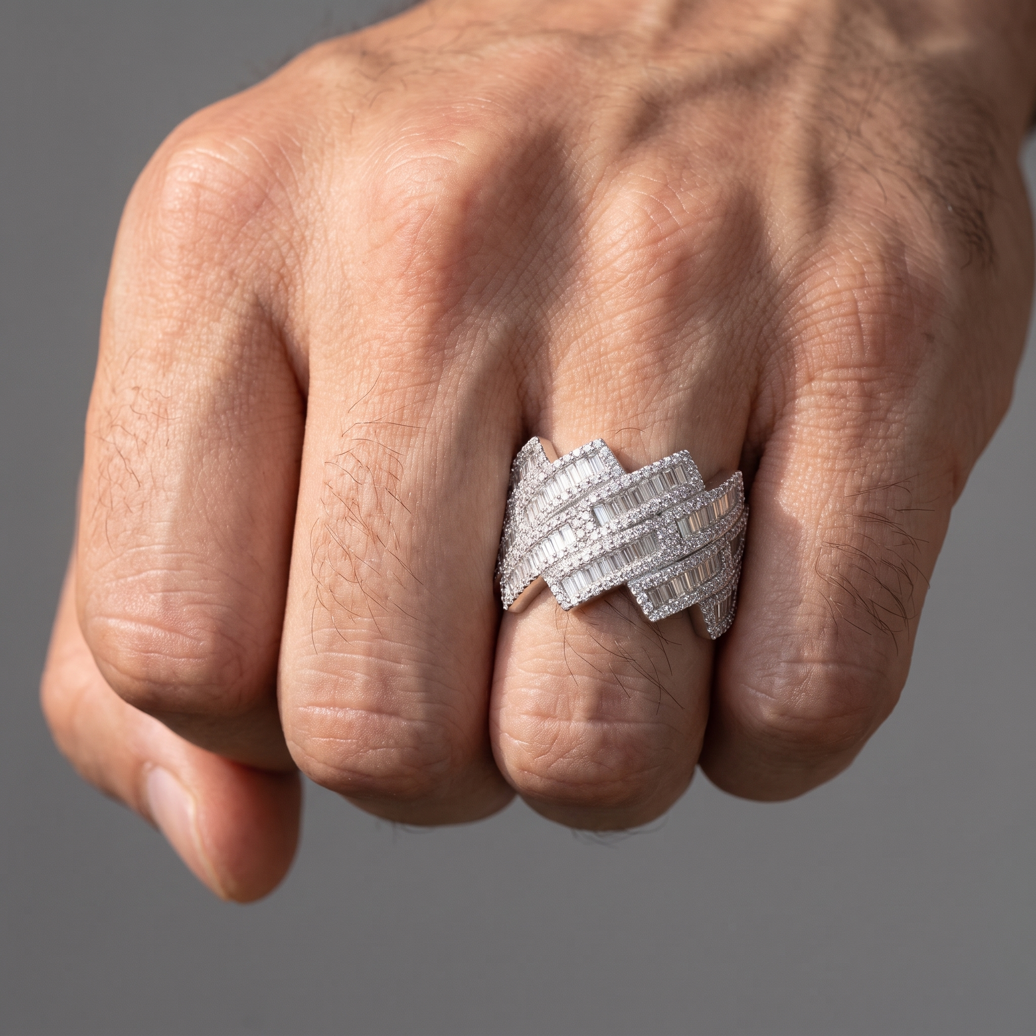 4.5ct lab diamond weave ring worn on a closed fist, ring finger
