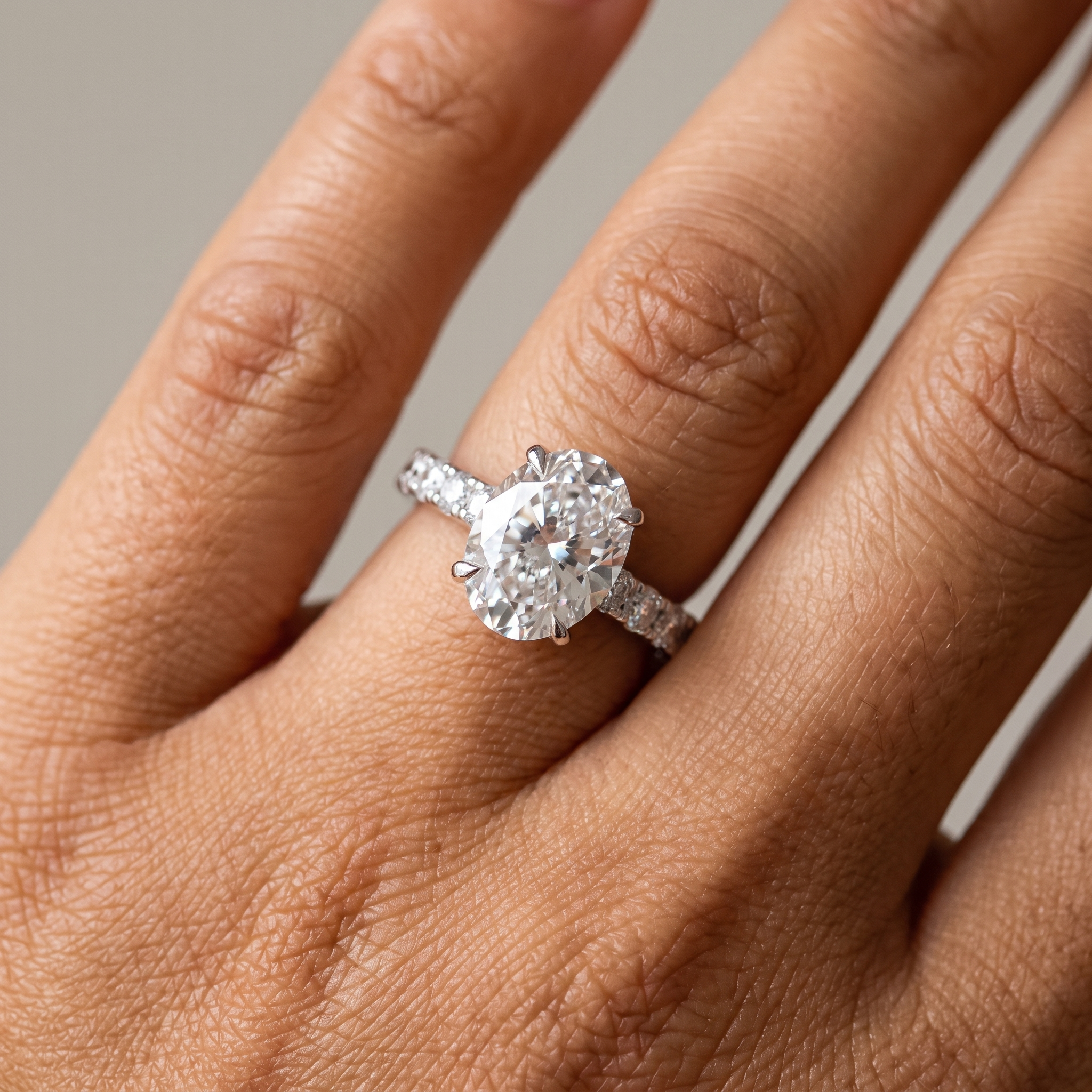 5.1ctw oval cut lab grown diamond engagement ring worn on the hand