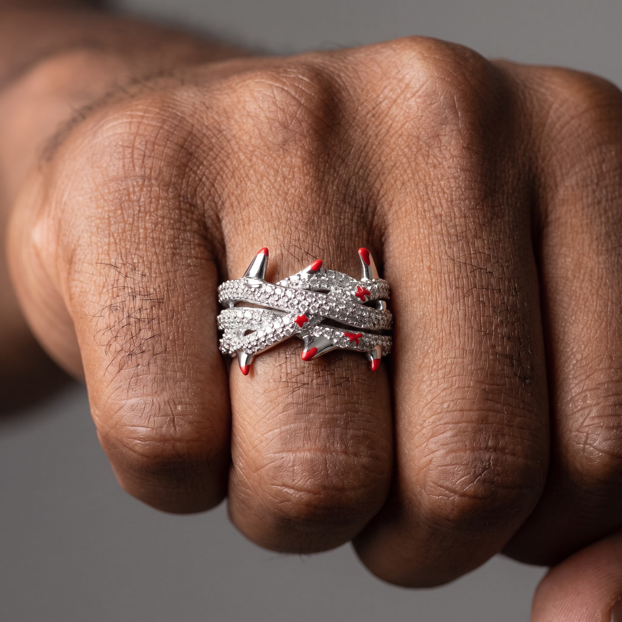 2.55ct Crimson Thorns lab diamond ring worn on the hand, thorn profile and red enamel tips visible against the finger