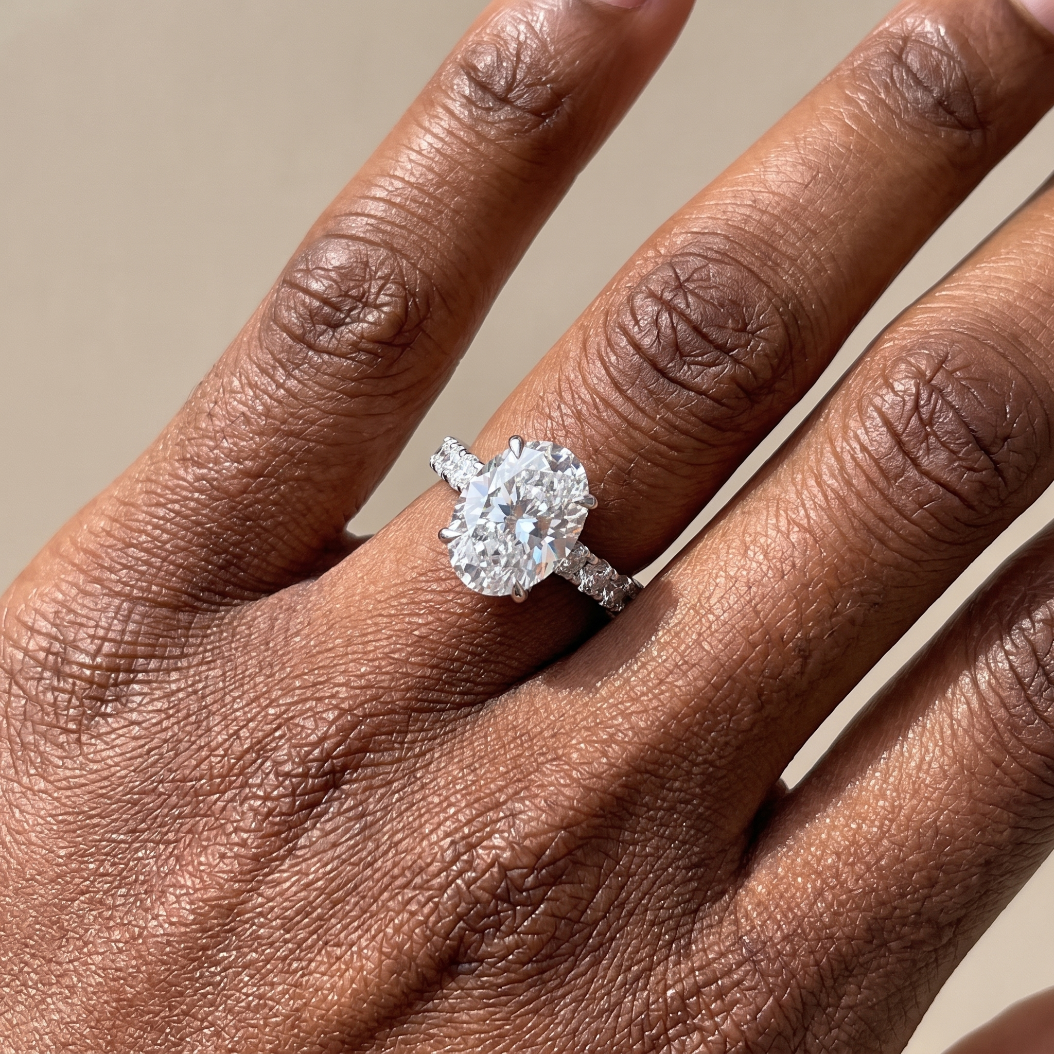 5.1ctw oval cut lab grown diamond engagement ring worn on the hand, three quarter view